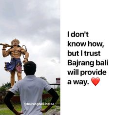 a man standing in front of a statue with the words i don't know how, but trust bajirang bali will provide a way