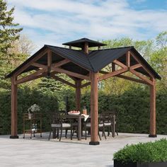 a wooden gazebo sitting on top of a stone patio