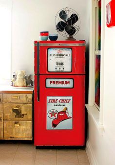 an old fashioned fire chief refrigerator in the corner of a room with white walls and tile flooring