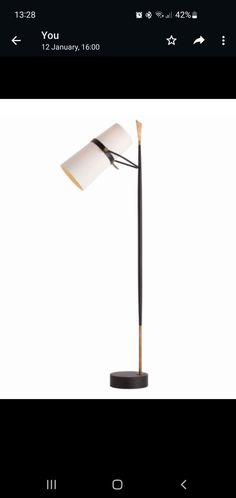 a lamp that is sitting on top of a wooden pole with a white light in the middle