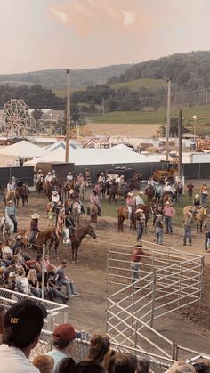 a group of people riding on the backs of horses in an arena at a rodeo