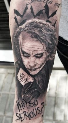 the joker tattoo is on someone's leg