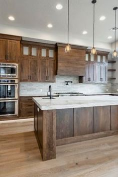 a large kitchen with wooden cabinets and an island