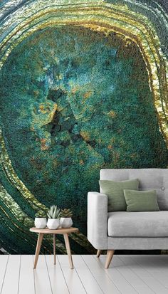 a living room with a couch, table and large wall mural in the middle of it