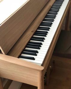 a close up of a piano keyboard on a wooden table