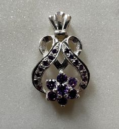 This handmade 925 sterling silver pendant is Heart shaped with Purple CZ Cubic Zircon . Pendant Height : 2.7 cm(approx) Pendant Width : 1.7 cm(approx) Pendant Weight : 4.70 grams(approx) Stone Colour : Purple Large Round Stone Center Flower Pattern  : 3mm(approx) Small Round Stone                                           :1.5mm Best Quality Guaranteed Why to wear silver? As a metal, silver has significant health benefits that have been used across cultures for centuries. Silver has a proven tra Sterling Silver Necklace With Accent Stones For Gift, Silver Necklaces With Accent Stones For Gifts, White Gold Sterling Silver Jewelry With Stone Setting, Hallmarked Cubic Zirconia Pendant Jewelry, Sterling Silver Heart Pendant With Prong Setting, Sterling Silver Heart Pendant Jewelry With Prong Setting, Silver Heart Pendant Jewelry With Gemstone, Silver Heart Pendant With Prong Setting, Sterling Silver Necklace With Prong Setting