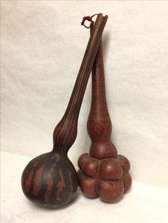 an old wooden instrument and some balls on a white tablecloth with a long stick sticking out of it