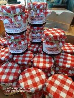 many red and white checkered cookies wrapped in twine with baby love labels on them