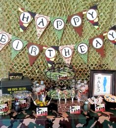 an army themed birthday party with camo and camouflage decorations, candy bar and candies