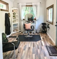 a room with a chair, mirror and rug in it