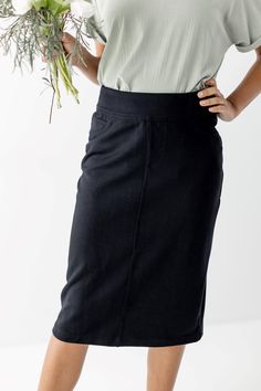 Classic black meets the comfort of stretchy knit denim! The 'Sara' Knit Denim Skirt in black is a wardrobe must-have that you'll reach for again and again. Featuring a wide waistband for a super-comfy fit and functional back pockets. You can style this stretchy skirt with a simple tee or a flowy top. You won't have to sacrifice style or comfort with this one! 66% Cotton 34% Nylon Wash Cold Gentle Cycle Hang to Dry Low Iron if Needed Model Height 5'3" | Wearing Size 6 in 26" Length Model Height 5 Modest Wardrobe, Stretchy Skirt, Knit Denim, Simple Tees, Church Outfits, Flowy Top, Again And Again, Flowy Tops, Low Iron