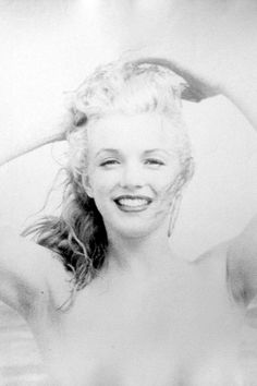 an old black and white photo of a woman with her hair blowing in the wind