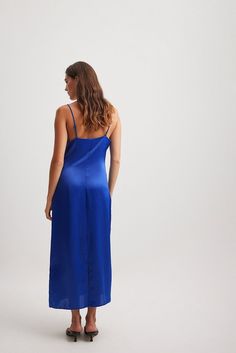 This slip dress features a midi length, a soft satin touch and a flowy fit. It has adjustable, thin shoulder straps, a back slit detail and a concealed side zipper. Marine Uniform, Satin Slip, Satin Slip Dress, Dress Blue, Midi Length, Shoulder Straps, Side Zipper, Blue Dresses, Slip Dress