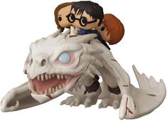 an action figure riding on the back of a white dragon with blue eyes and long hair