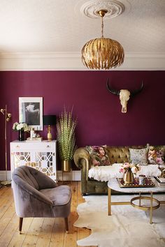 a living room with purple walls and furniture