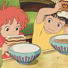 two children sitting at a table with bowls of cereal and pizza in front of them