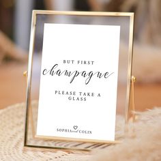 there is a sign that says but first champagne please take a glass on the table