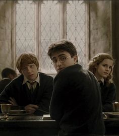 harry potter and his friends are sitting at the table