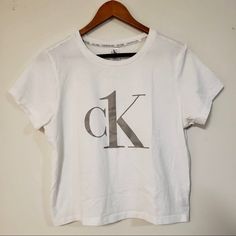 Size L. Never Worn Calvin Klein Cotton Tops For Loungewear, Calvin Klein Basic Short Sleeve Tops, Calvin Klein Cotton Loungewear Tops, Calvin Klein White Logo Print T-shirt, Calvin Klein White Short Sleeve Top, White Calvin Klein Crew Neck T-shirt, Calvin Klein Summer Logo Print Top, Calvin Klein White Crew Neck T-shirt, White Calvin Klein T-shirt For Spring