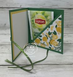 an open card with lemons on it and a green ribbon tied around the edge