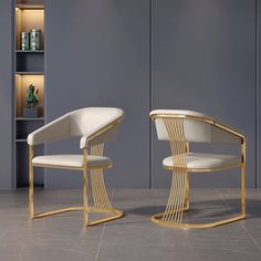 two white chairs sitting next to each other in front of a book shelf filled with books