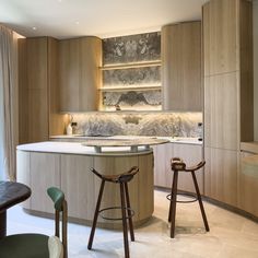 two stools sit in front of a kitchen island