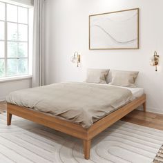 a bed sitting in a bedroom on top of a wooden floor next to a window