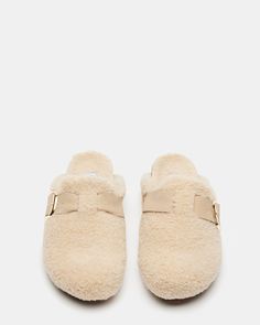 RELAXED + COZY + LOW KEY CUDDLE is the open back clog that feet can't get enough of. Super soft faux shearling both inside and out gives these comfy slides that walking-on-clouds feel. Cork accenting the midsole adds contrasting texture to this fuzzy design. Flatform mule clogs Slip-on style Cork wrap midsole Faux shearling exterior and interior Buckle hardware accent at side 1 inch heel height Faux shearling upper material Faux shearling lining Faux shearling sock Faux shearling sole Imported Winter Clogs, Comfy Slides, Cute Slides, Steve Madden Store, Shoes Ideas, Apparel Merchandising, Walking On Clouds, Low Key, Mule Clogs