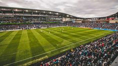 an overhead view of a soccer stadium with many people on the field and in the stands