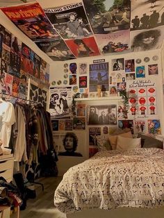 a bedroom with posters on the wall and bed