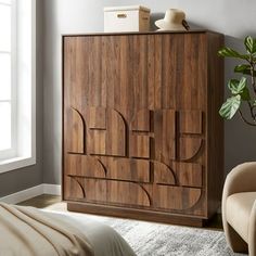 a bedroom scene with focus on the bed and wooden cabinet in the foreground,