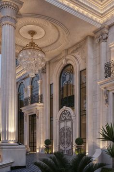 an elegant building with columns and chandeliers