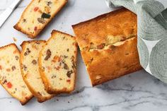 slices of bread sitting on top of a white counter next to a knife and fork