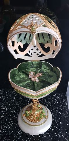 an elaborately decorated jewelry box sitting on top of a table