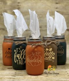 four mason jars with tissue dispensers in them