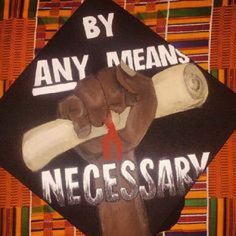 a graduation cap with an image of a baseball bat and the words by any means necessary