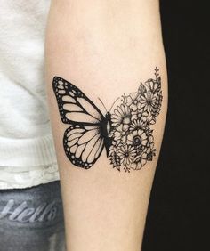 a black and white butterfly tattoo on the arm