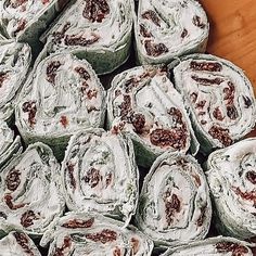 several rolls of food sitting on top of a wooden table