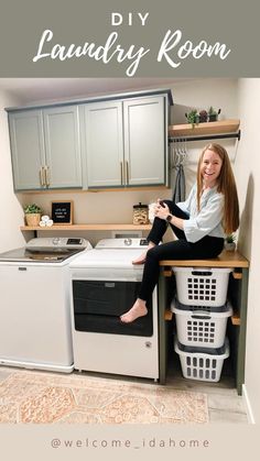 a woman sitting on top of a laundry room counter