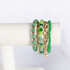 Consists of 5 bracelets "Turn your green dreams into reality with our Green Come True Bracelet Stack. This stack features a stunning shade of green, adding a pop of color to any outfit. Get ready to make a statement and stand out from the crowd. Gold cuff- (one size…if require smaller or larger contact us first so we can suggest an alternate bracelet) Roma Chain Bracelet (one size…if require smaller or larger contact us first so we can suggest an alternate bracelet) (60000303) Dark Emerald Facet Adjustable Green Crystal Bohemian Bracelet, Stackable Green Beaded Bracelets, Trendy Green Stackable Jewelry, Trendy Green Stretch Bracelet Stackable, Trendy Green Stackable Stretch Bracelet, Adjustable Green Wrap Bracelet With Round Beads, Green Adjustable Bangle Stretch Bracelet, Green Stretch Bangle Bracelet, Green Stackable Bracelets For Gift