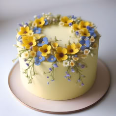 a cake with yellow and blue flowers on it