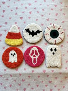 halloween themed felt appliques are displayed on a pink and white tablecloth with hearts