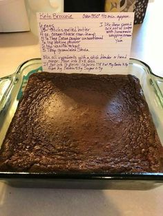 a chocolate cake sitting on top of a pan covered in frosting and writing notes