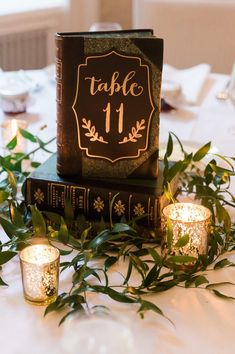 a table with candles and some books on it