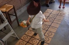 a little boy standing on top of a wooden floor