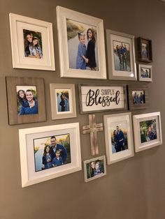 a wall with many pictures and a cross on it