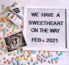 we have a sweetheart on the way sign next to some candy candies and sneakers