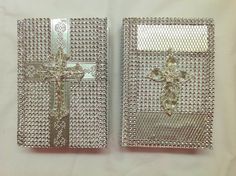 two silver colored metal cross brooches on white cloth