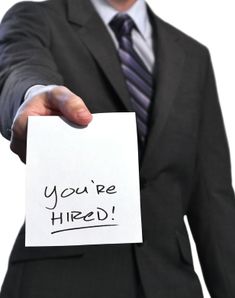 a man in a business suit holding a piece of paper with the words you're fired written on it