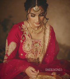 a woman in a red outfit with gold jewelry